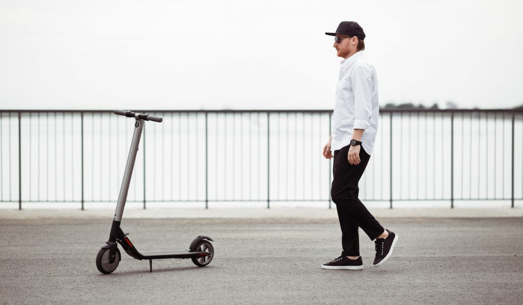 modern man with electric scooter