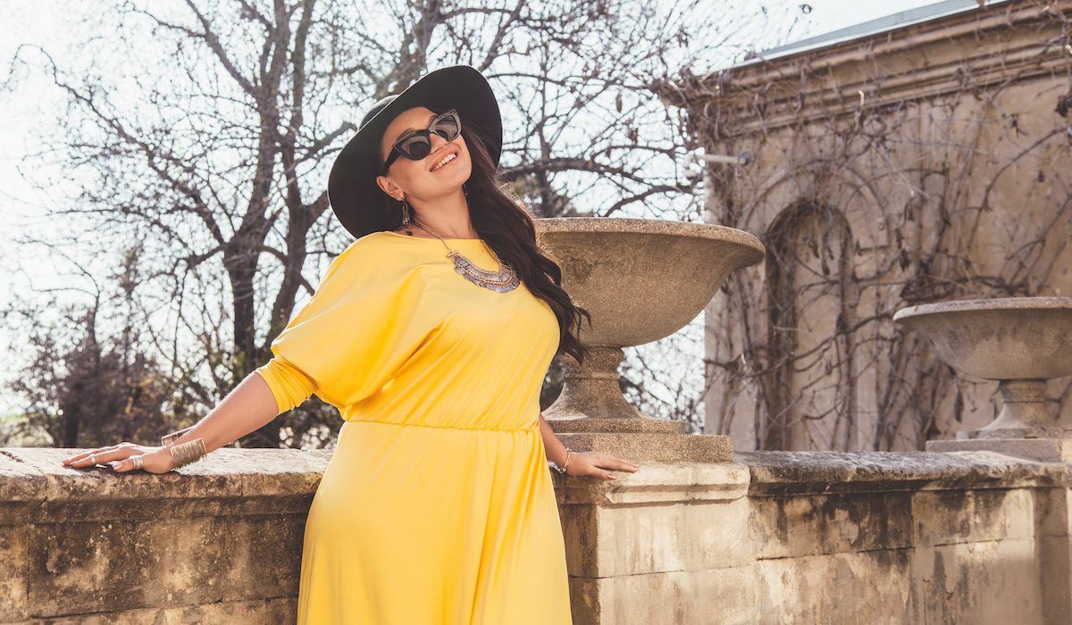 stylish woman wearing a yellow dress with accessories