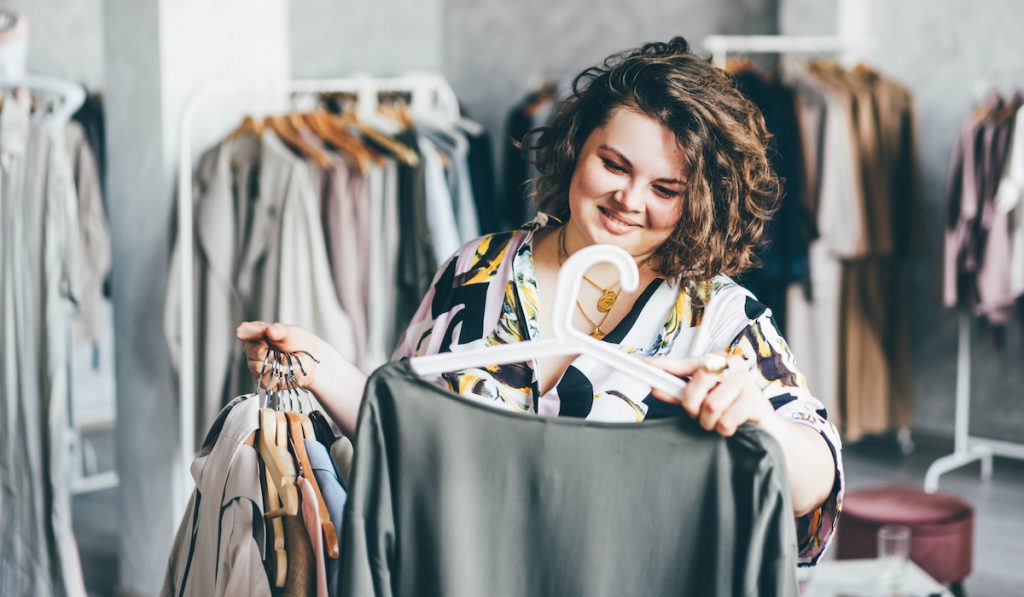 plus size woman looking at cloths to buy