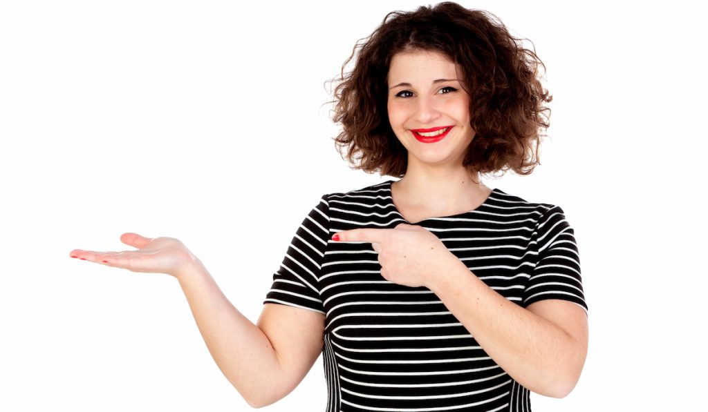 woman wearing striped clothing and pointing sideways