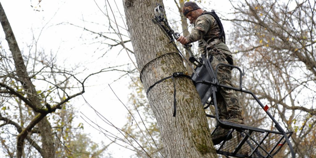 Bow hunter on a tree stand