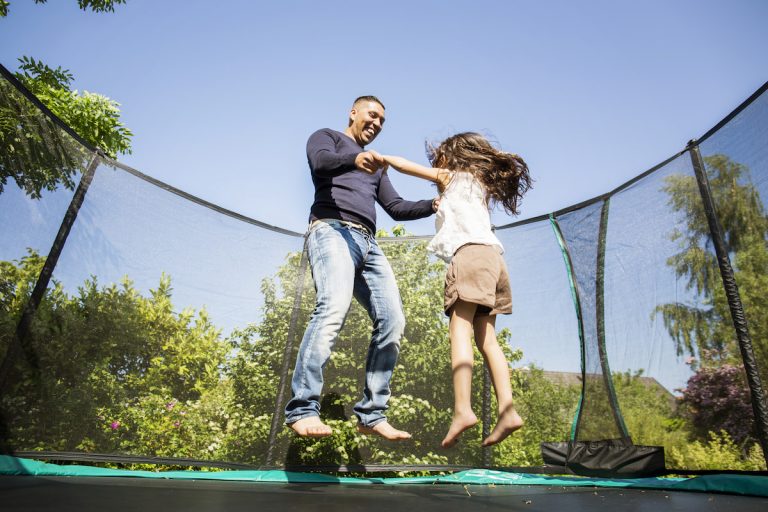 father-and-daughter-jumping-on-trampoline