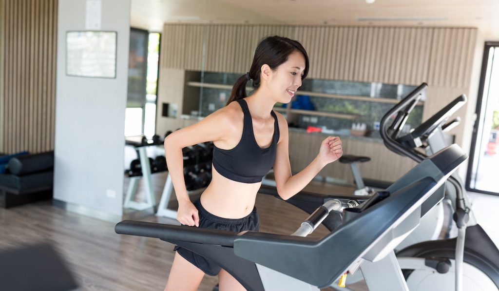 woman training running on treadmill 