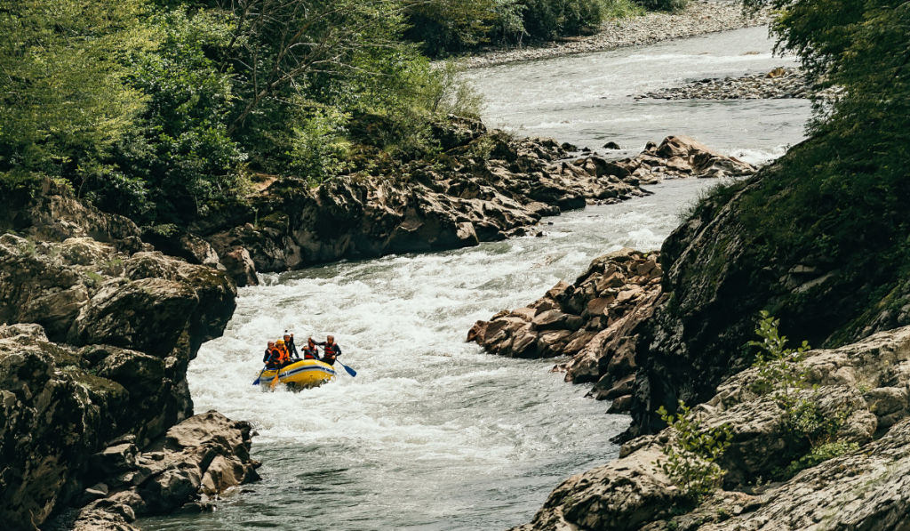 Active group outdoor recreation, fun rafting in a stormy mountain river