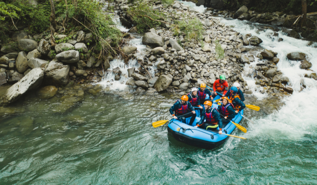 Group of people rafting in rubber dinghy on a river