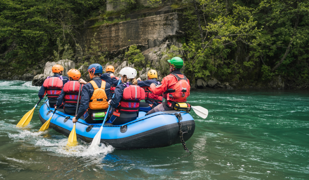 Group of people rafting in rubber dinghy on a river 