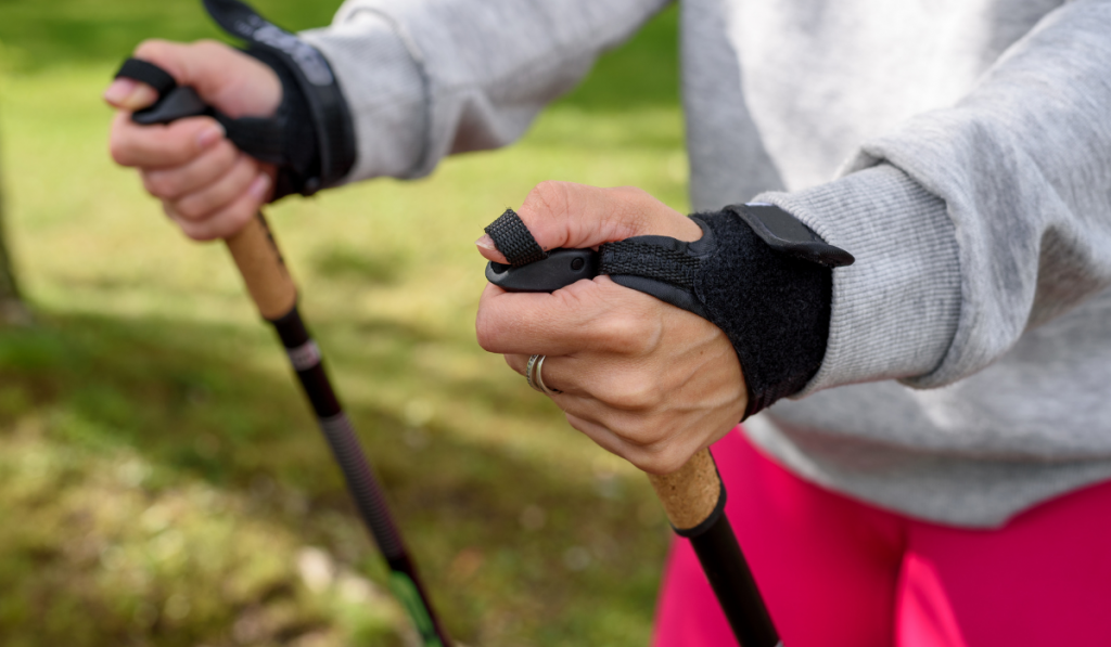 Woman holding poles for nordic walking
